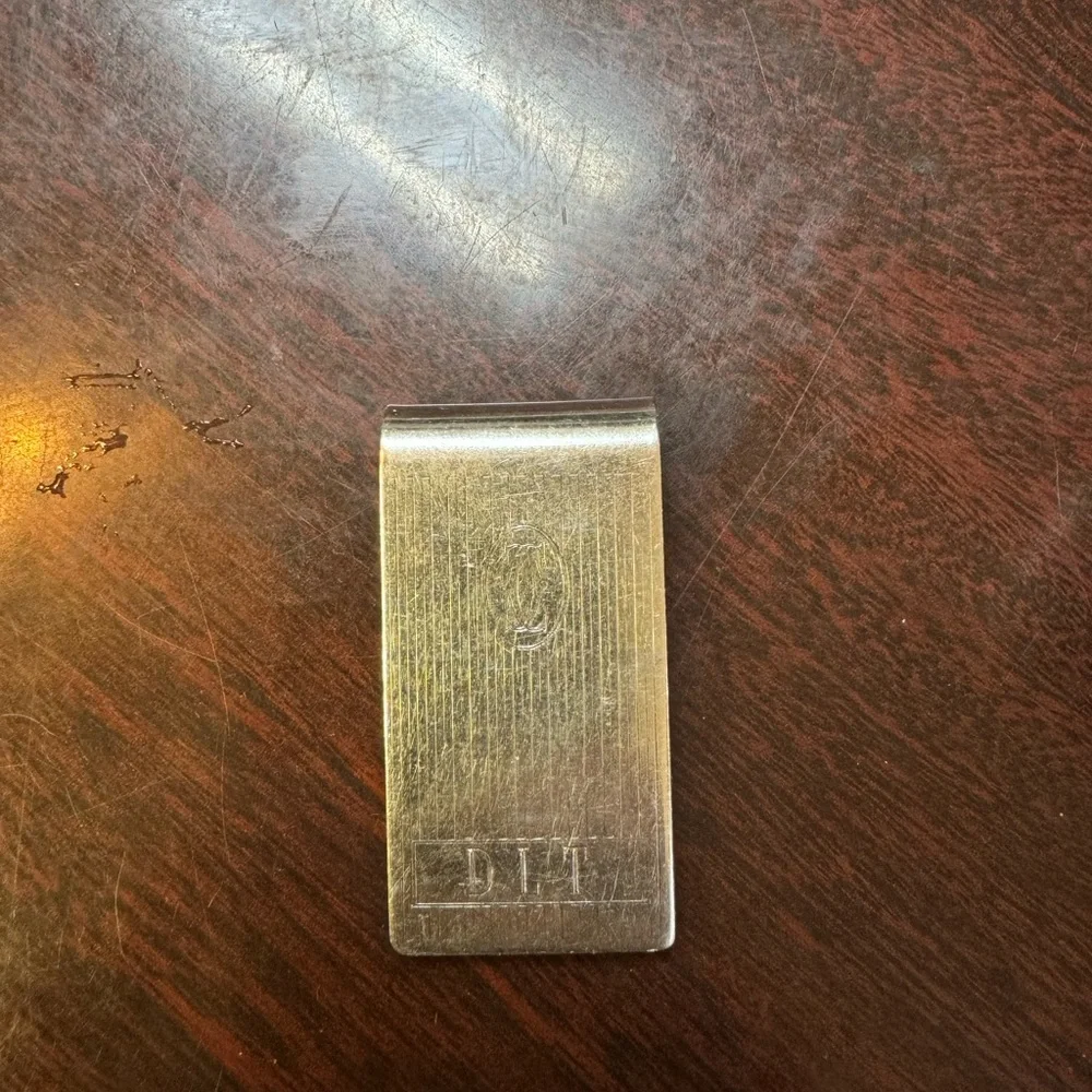 Cartier sterling silver money clip. Engraved with initials DLT.